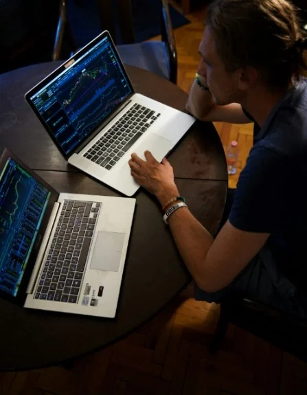 Trader reviewing charts on a laptop